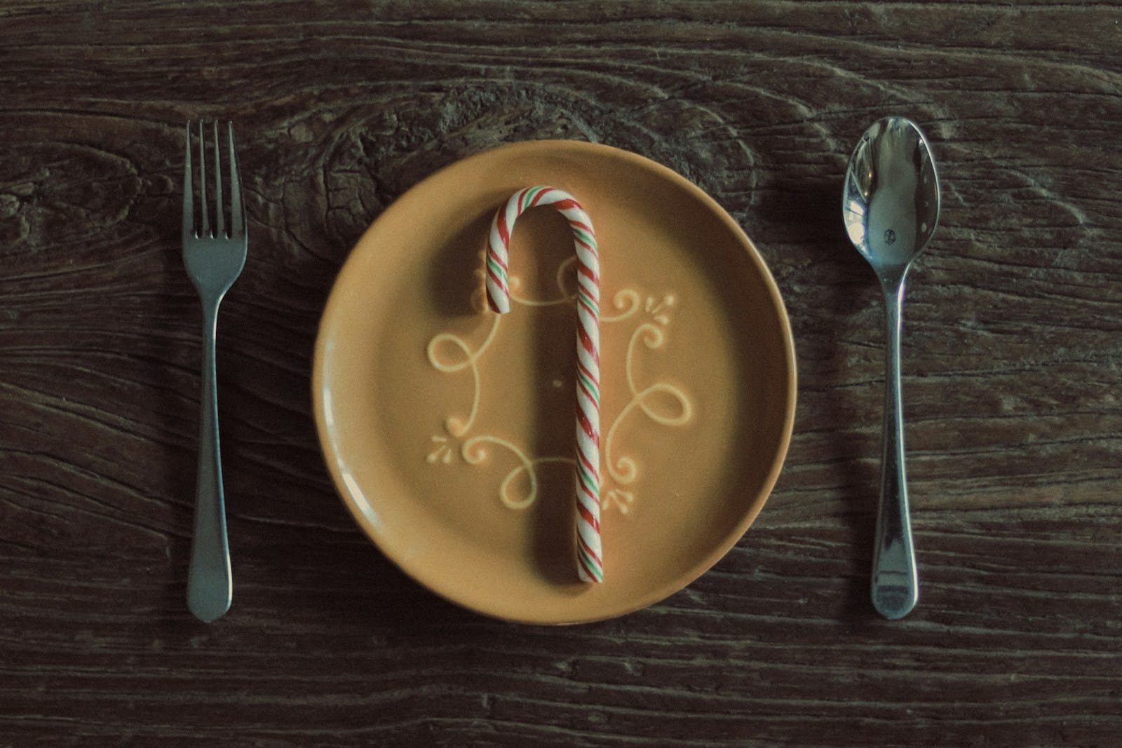 A plate that has a candy cane on it